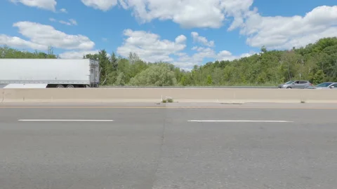 Driving  POV side view on highway at high speed with cars and truck traffic Stock Footage 158322176