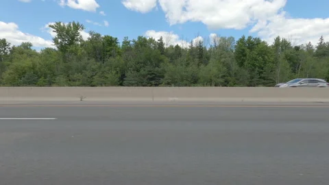 Driving  POV side view on highway at high speed with cars and truck traffic Stock Footage 158322975