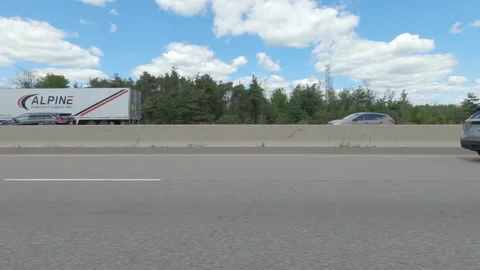 Driving  POV side view on highway at high speed with cars and truck traffic Stock Footage 158323996