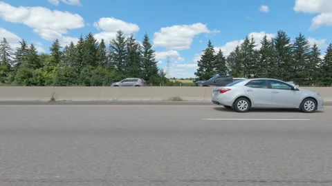 Driving  POV side view on highway at high speed with cars and truck traffic Stock Footage 158328486