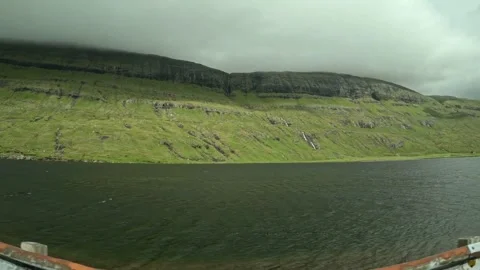 Driving POV side window shot of Saksun lagoon and green mountains, Faroe Islands Stock-Footage 339481916
