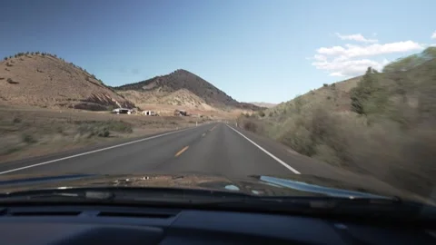 Driving POV through dry rolling hills on a highway in Central Oregon Stock Footage 346794758