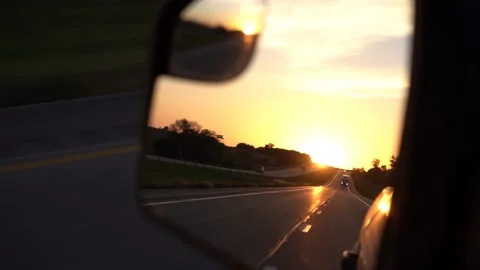Driving POV through the rear view mirror at sunrise Video stock 162119191