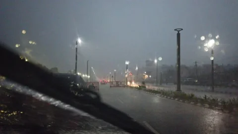 Driving POV in vizag bach road in heavy rain with seatbelt beep Stock Footage 138489853