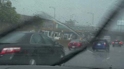 Driving POV of windshield wipers, rain, and city traffic Stock-Footage 111834372