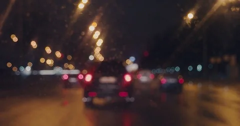 Driving in the rain on busy overpass looking at rear lights of other cars 動画素材 106063618