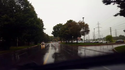 Driving Rain City Street Under Overcast Sky in Summer Day. Stock Footage 115995140