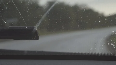 Driving in the rain. Inside car with rain drops on car windshield. Stock Footage 115859465
