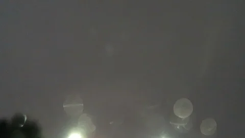 Driving in the rain in LA, looking up into the rain. Stock Footage 99605384