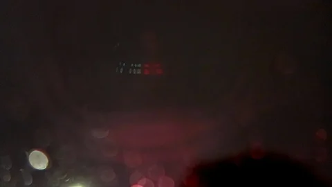 Driving in the rain in LA, looking up into the rain. Stockbeeldmateriaal 99605643