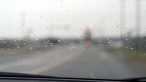 Driving in rain, out of focus background and headlights, dreary day, handheld. Stock Footage 111982113