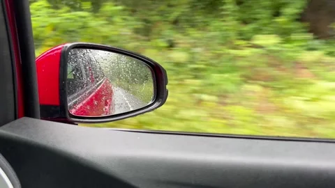 Driving in rain POV from car side mirror Stock Footage 340830891