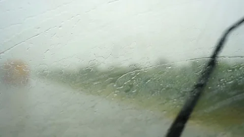 Driving in rain view from inside car with drops on car windshield. Slow motion Stock Footage 121405154