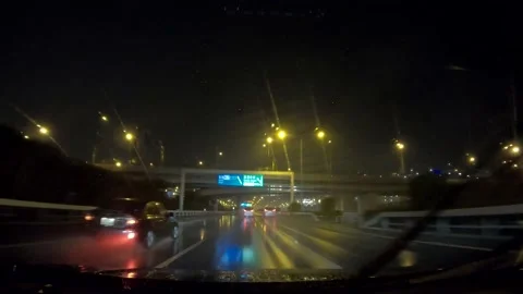 Driving rainy and dark midnight highway between building in Japan Video stock 155449972