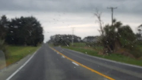 Driving in rainy condition with a camera focused on the window to display Stock Footage 98386281