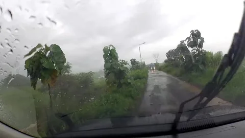 Driving on a rainy rural road with windshield wiper in motion Video stock 279717872