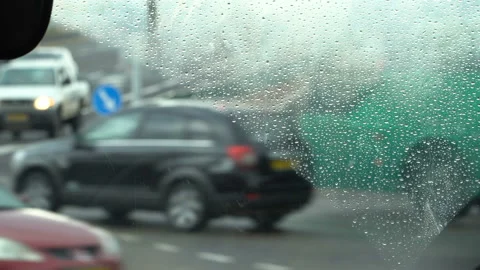 Driving in rainy weather. View from the driver angle. Rain splashed windshield. Stock Footage 88718217