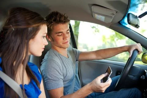 Driving: reading a text message while driving Stock Photos