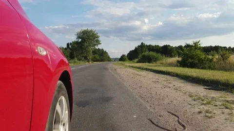 Driving a red car over the road along the asphalt at speed, view from the wheel. Stock Footage 135992043