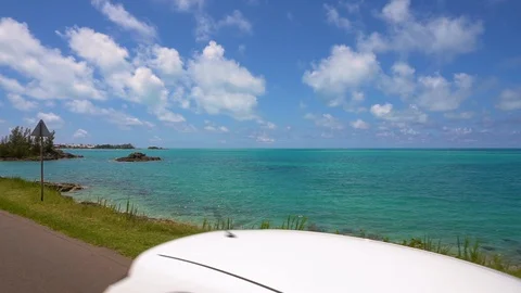 Driving on the road off the coast of Bermuda, with the view of the ocean. Video stock 129394486