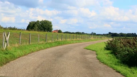 Driving road next to a dike, north Germany, idyllic Stock Footage 188520640