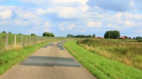 Driving road next to a dike, north Germany, idyllic Stock Footage 194545131