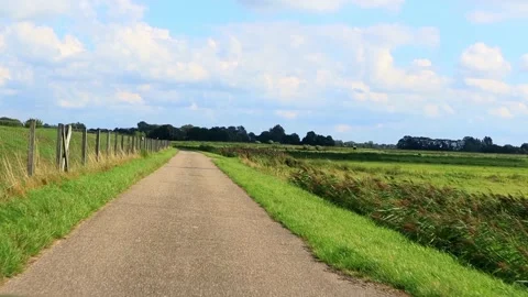 Driving road next to a dike, north Germany, idyllic Stock Footage 214834359