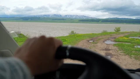 Driving off-road on a scenic lakeside route Видео 340264548