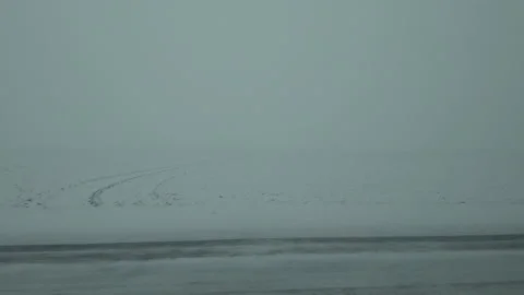 Driving on the road through landscape covered in snow Video stock 169651224