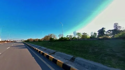 Driving on a Road, Trees  are aside in a bright sunny day Stock Footage 173224562