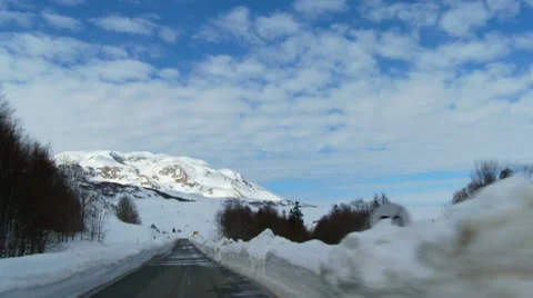 Driving on the roads fenced with a large layers of snow Stock Footage