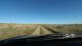 Driving on rough rural dirt road between two fields. Saskatchewan, Canada. HD Footage