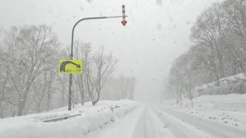 Driving round a road bend in heavy blizzard winter snowstorm Stock Footage 272894869