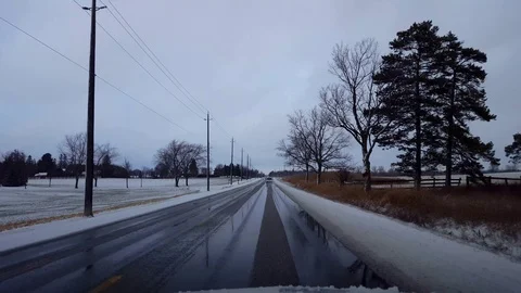 Driving Rural Countryside Road in Winter With Snow on Side of Road in Day Stock Footage
