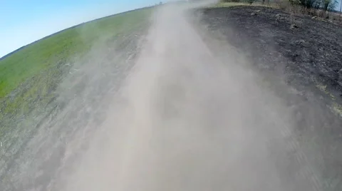Driving on rural dusty road. The camera is outside and aimed back. Stock Footage 49798254