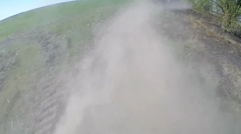 Driving on rural dusty road. The camera is outside and aimed back. Stock Footage 49798320