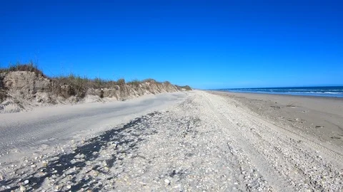 Driving sand and seashells Gulf of Mexico Texas beach POV 4K Stock Footage 102476173