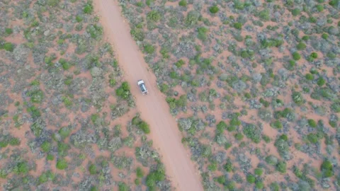 Driving On The Sandy Track Through Australian Outback. Aerial Topdown Shot Stock Footage 314323316