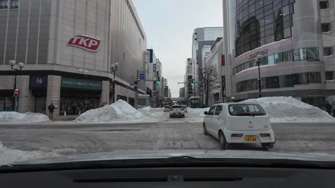 Driving in Sapporo city winter intersection traffic and snowy streets 스톡 동영상 333205095