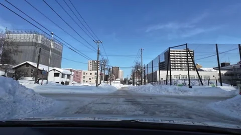 Driving in Sapporo rush hour turning right into heavy traffic winter 스톡 동영상 333229633