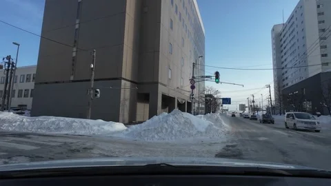 Driving in Sapporo turning left with roadside parking in winter 스톡 동영상 333229627
