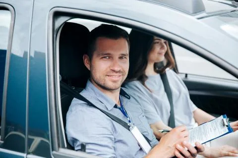 Driving school. Successfully passed test or exam. Male instructor loves his job Stock Photos