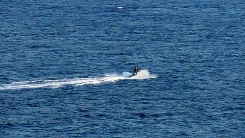 Driving a Scooter at a Seaside Stock Footage