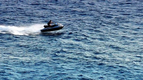 Driving a Scooter at a Seaside Stock Footage 80669220
