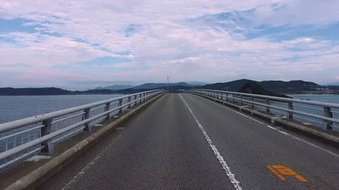 Driving shot of empty, straight road over ocean “Tsunoshima bridge” Stock Footage 77050896