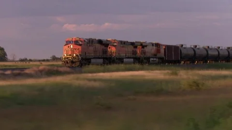 Driving shot of speeding freight train at sunset Stock Footage 84465512
