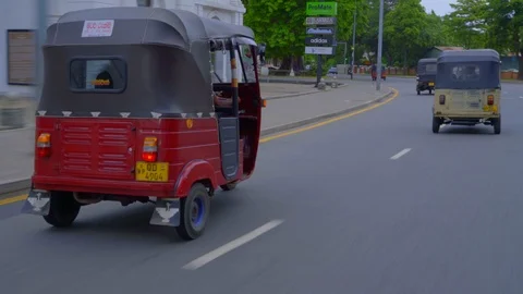 Driving side plate with view of keke napep, Sri Lanka Stock Footage 107536010