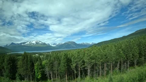 Driving side window view of Norwegian fjord and mountains in Northern Norway Stock-Footage 340960144