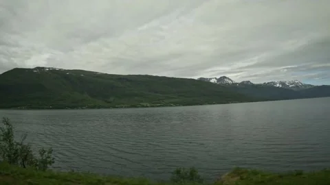 Driving side window view of overcast fjord and mountains in Northern Norway Vídeos de archivo 341272656