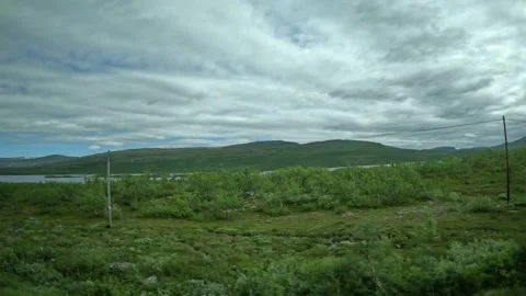 Driving side window view of tundra lake and distant fells in Lapland Finland 動画素材 340960136